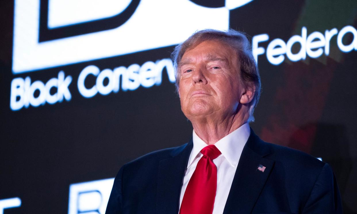 <span>Donald Trump receives applause during the Black Conservative Federation Gala on 23 February in Columbia, South Carolina.</span><span>Photograph: Sean Rayford/Getty Images</span>