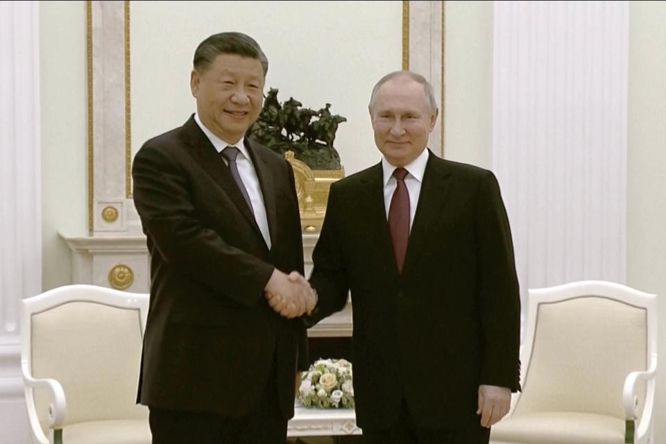 In this grab taken from video, China's President Xi Jinping, left, and Russian President Vladimir Putin shake hands during their meeting in Moscow, Russia, Monday, March 20, 2023. (Russian Pool via AP)