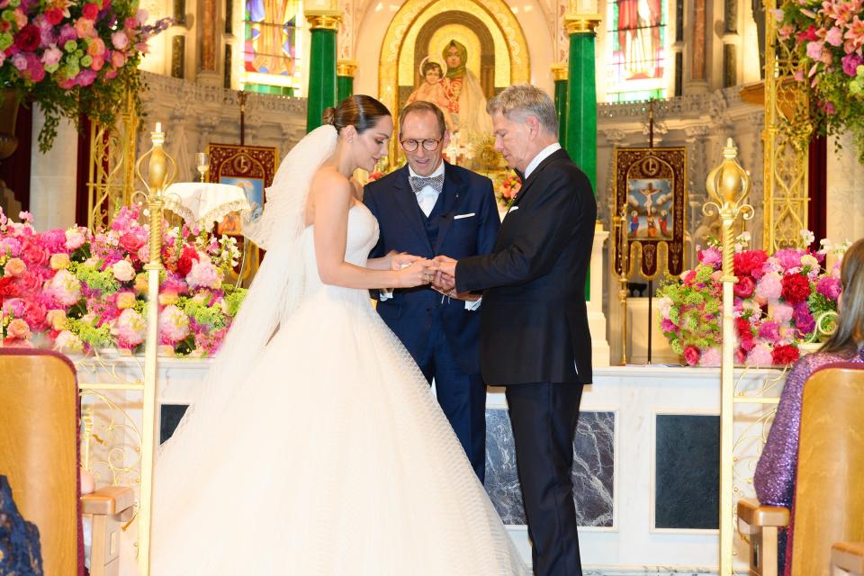 Katharine McPhee and David Foster exchanging rings and reciting vows.