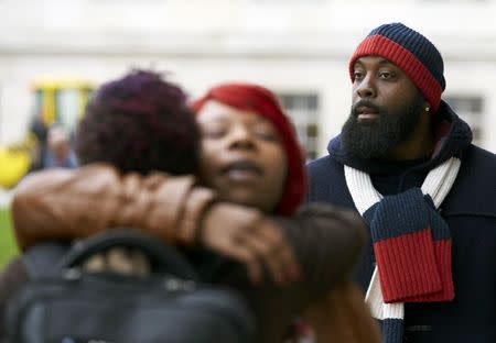 The mother, Lesley McSpadden (C) and father, Michael Brown Sr. (R) of slain teenager Michael Brown, leave after a news conference in Geneva November 12, 2014. REUTERS/Denis Balibouse