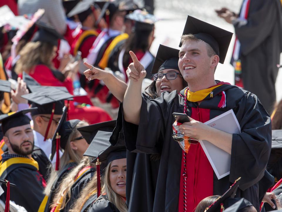 Graduates search for family and friends in 2019 during Rutgers University's Biomedical and Health Sciences commencement.