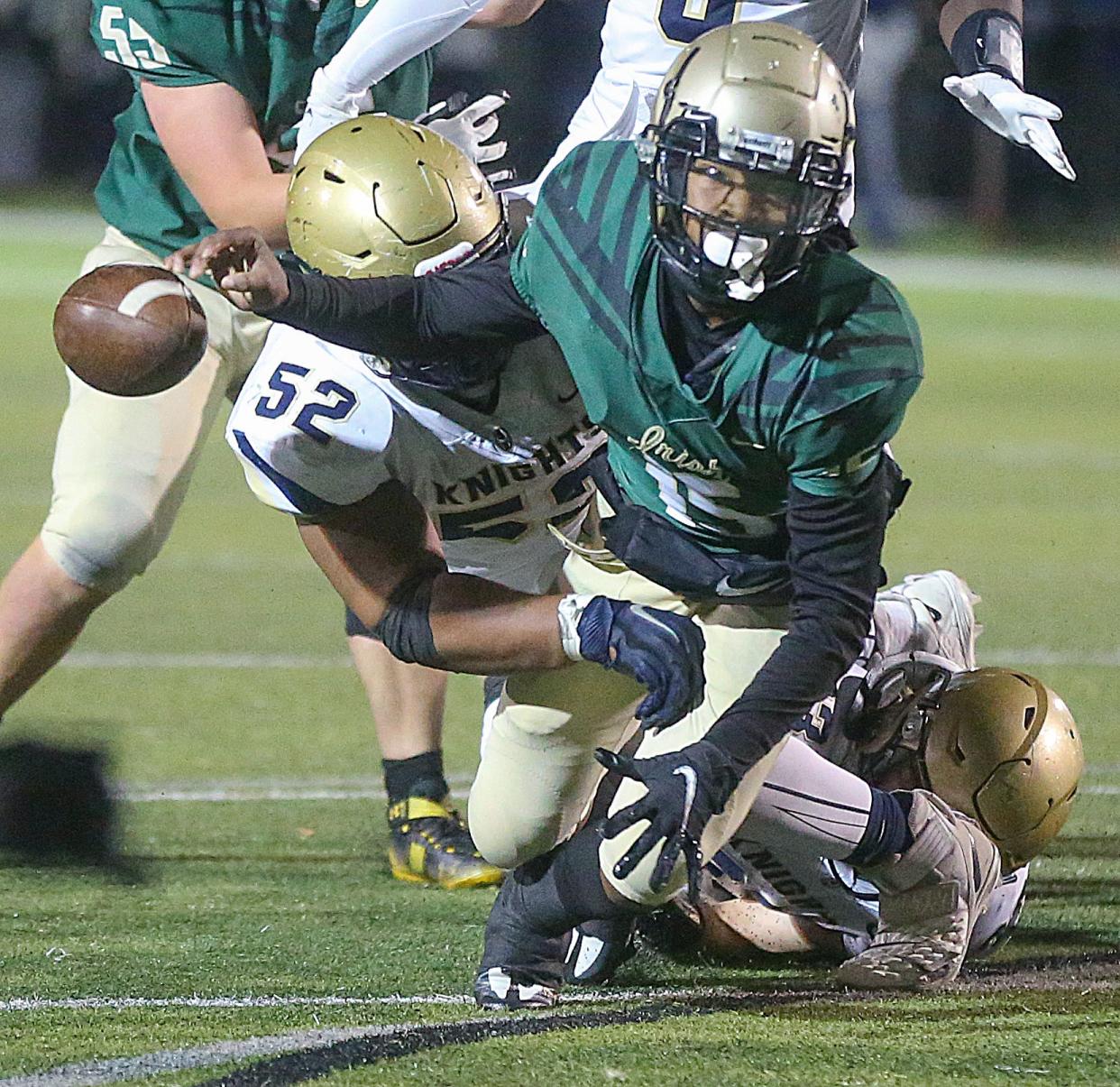 St. Vincent-St. Mary quarterback Markell Carter fumbles the ball after being tackled by Hoban's Jason Martin III during the third quarter on Friday, Oct. 7, 2022 in Akron, Ohio, at John Cistone Field.