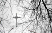 A cross sits atop a building at the Archdiocese of Denver campus on Wednesday, Jan. 18, 2023. The archdiocese is being sued by a man who alleges about 100 instances of abuse at St. Elizabeth Ann Seton Church in Fort Collins, Colo., from 1998 to 2003. The lawsuit is allowed under a 2021 state law that opened up a three-year window for people to pursue litigation for sexual abuse that happened to them as children dating as far back as 1960.(AP Photo/Thomas Peipert)