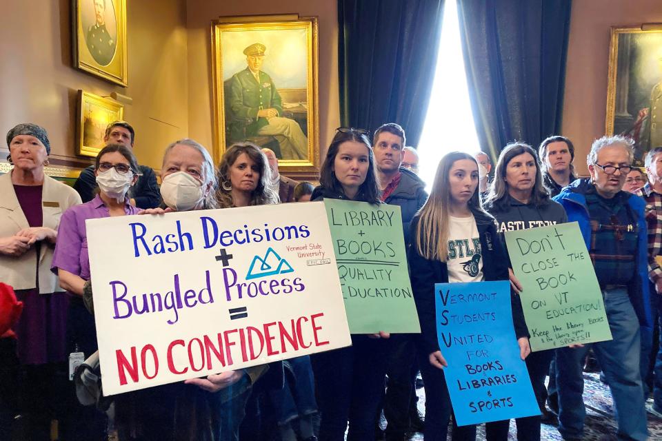 Students from some Vermont State Colleges, along with others, display signs Tuesday, Feb. 21, 2023, at the Statehouse in Montpelier, Vt., while protesting a decision by the schools' administration to shift to an an all-digital library for three of the schools.