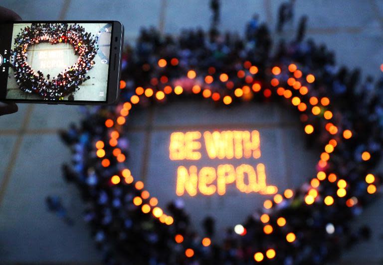 Nepalese and Chinese students gather to pray for Nepal in Nanhua University in Hengyang, central China's Hunan province