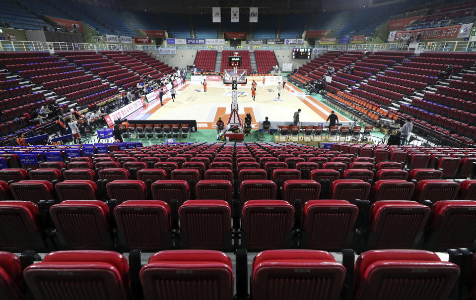 Stadium seats are empty during the Korean Basketball League between Incheon Electroland Elephants and Anyang KGC clubs in Incheon, South Korea, Wednesday, Feb. 26, 2020. The basketball game held without spectators as a precaution against the COVID-19. (Yun Tai-hyun/Yonhap via AP)