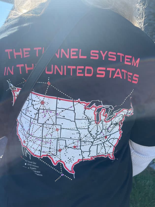 A woman at the Great ReAwakening event shows off a shirt mapping out underground tunnels across the U.S. where she believes the Illuminati are harvesting children's blood. (Photo: Christopher Mathias / HuffPost)