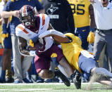 Virginia Tech's Jalen Holston, left, is tackled by West Virginia's Lance Dixon during the first half of an NCAA college football game in Morgantown, W.Va., Saturday, Sept. 18, 2021. (AP Photo/William Wotring)