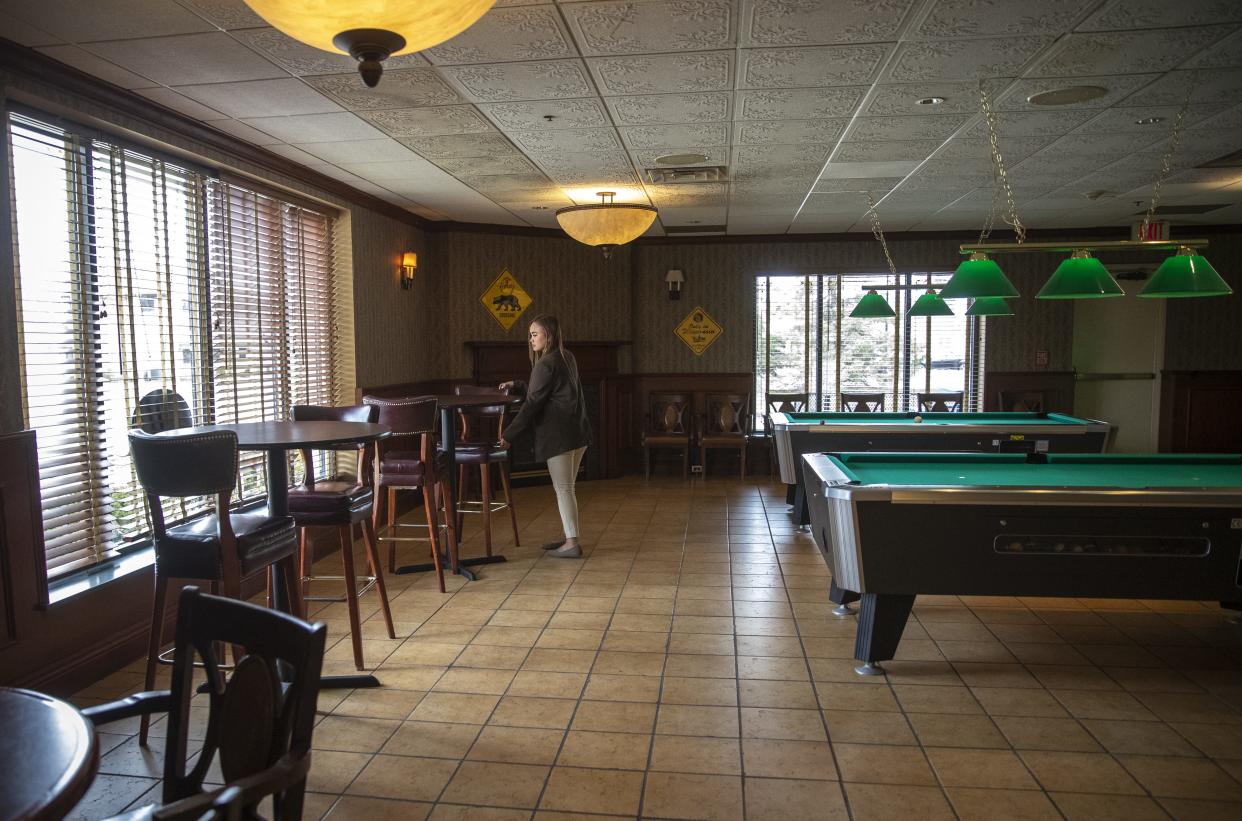 Hotel Mead Resorts & Convention Centers General Manager Lucky Richardson arranges chairs in the hotel's Grand Avenue Tavern on Tuesday in Wisconsin Rapids.