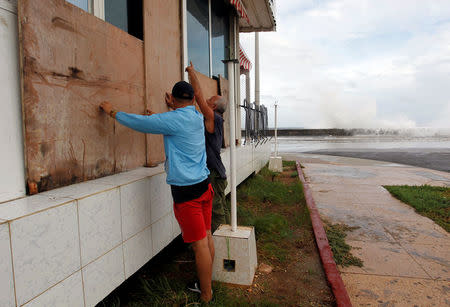 People protect windows with wooden boards ahead of the passing of Hurricane Irma, in Havana, Cuba September 9, 2017. REUTERS/Stringer