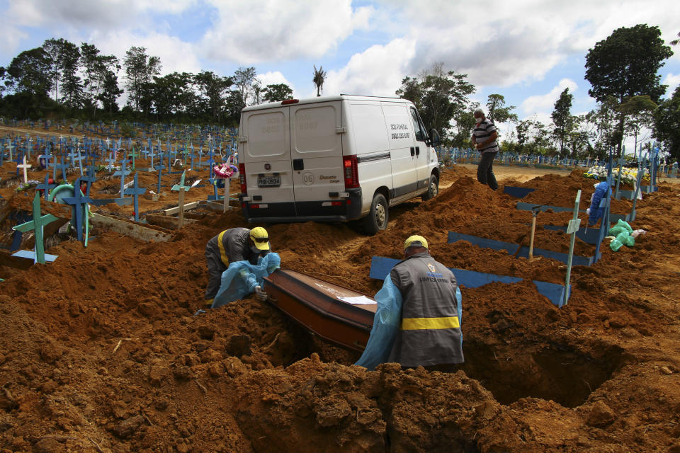 FILE - In this Jan. 6, 2021 file photo, cemetery workers bury 89-year-old Abilio Ribeiro, who died of the new coronavirus, at the Nossa Senhora Aparecida cemetery in Manaus, Amazonas state, Brazil. The country has suffered more than 200,000 COVID-19 deaths, the second-highest total in the world after the United States, with infections and deaths surging again. (AP Photo/Edmar Barros)