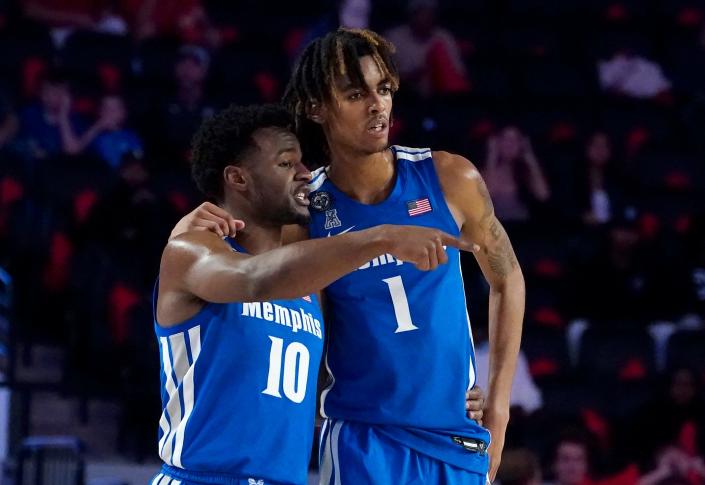 Memphis guard Alex Lomax (10) and forward Emoni Bates (1) talk during a break in the action during the first half of an NCAA college basketball game against Georgia Wednesday, Dec. 1, 2021, in Athens, Ga. (AP Photo/John Bazemore)