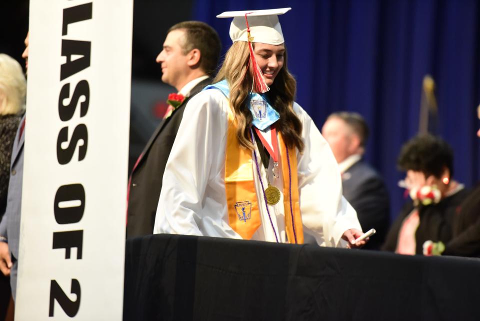 Graduating seniors walk off the stage after being handed their diplomas during the Port Huron High School commencement ceremony at McMorran Arena in Port Huron on Wednesday, June 8, 2022.