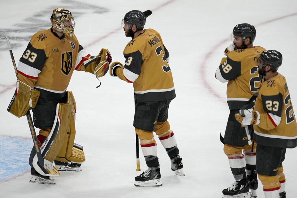 Vegas Golden Knights players greet goaltender Adin Hill (33) after Game 1 of the NHL hockey Stanley Cup Finals against the Florida Panthers, Saturday, June 3, 2023, in Las Vegas. The Golden Knights defeated the Panthers 5-2. (AP Photo/Abbie Parr)