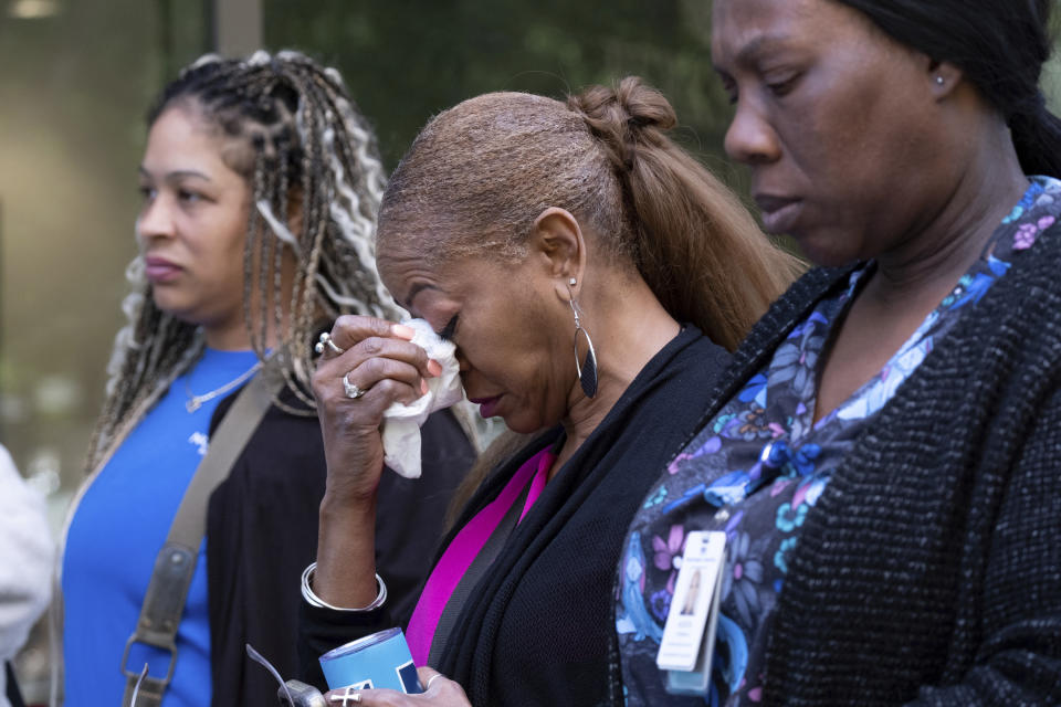 A woman tears up after evacuating following a shooting at a medical building in Midtown Atlanta on Wednesday, May 3, 2023. (AP Photo/Ben Gray)