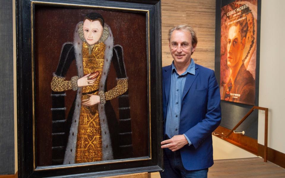 Philip Mold next to one of the earliest portraits of Queen Elizabeth I hanging in the Philip Mold & Co gallery, Pall Mall