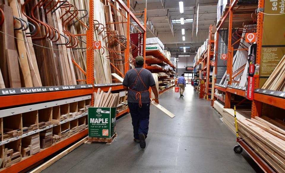 An employee works the lumber section at a Home Depot store in Alhambra, California on May 4, 2022. - The US central bank announced its biggest interest rate hike in over twenty years as it deals with fast rising home, gas and food prices in the US economy. (Photo by Frederic J. BROWN / AFP) (Photo by FREDERIC J. BROWN/AFP via Getty Images)