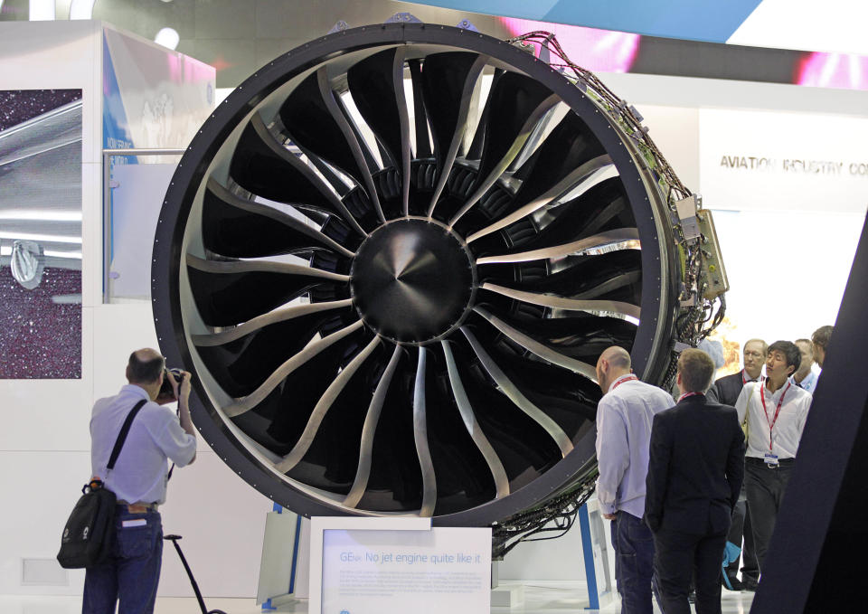 Visitors watch General Electric's turbo fan "the GEnx engine, powering Boeing 787 Dremliner, during the 50th Paris Air Show at Le Bourget airport, north of Paris, Wednesday June 19, 2013. (AP Photo/Remy de la Mauviniere)