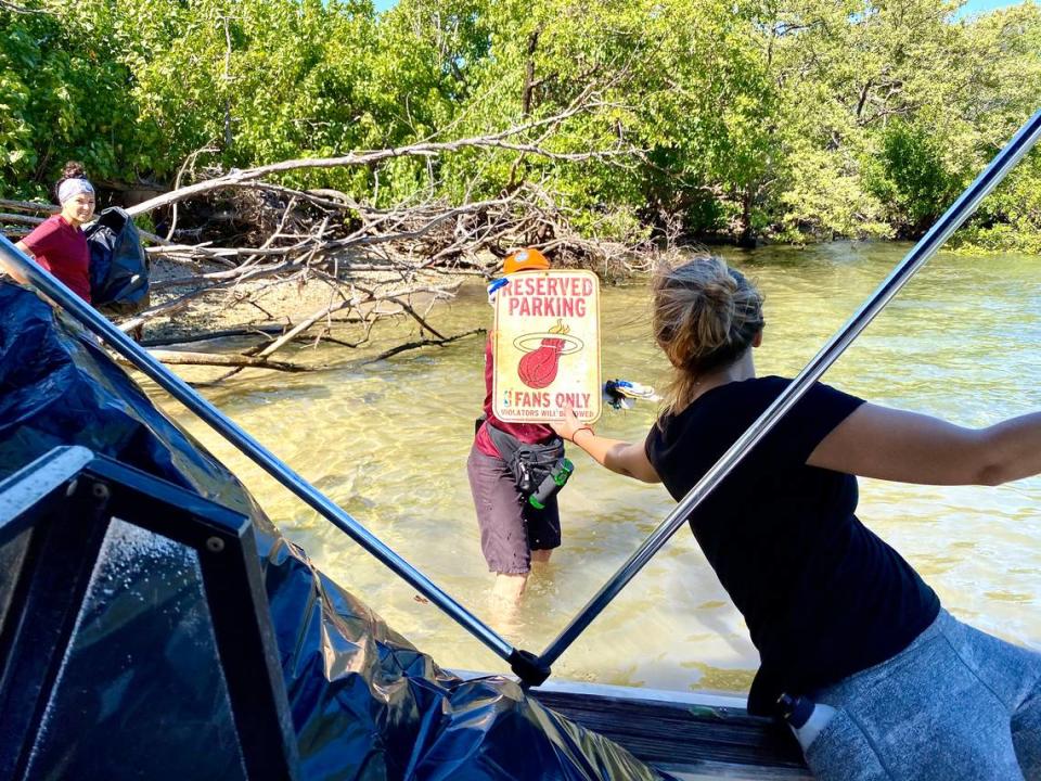 A discarded parking sign for a Miami Heat fan somehow made its way to Bird Key in Biscayne Bay. It was found by volunteers among decades of trash on the island.