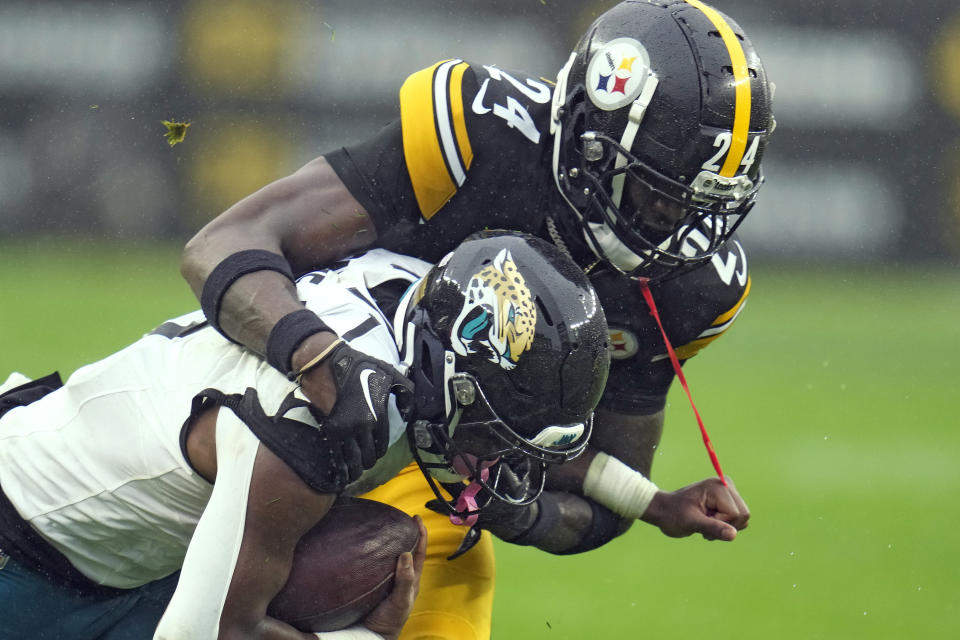 Pittsburgh Steelers cornerback Joey Porter Jr. (24) stops Jacksonville Jaguars running back Travis Etienne Jr. (1) on a run during the first half of an NFL football game Sunday, Oct. 29, 2023, in Pittsburgh. (AP Photo/Gene J. Puskar)