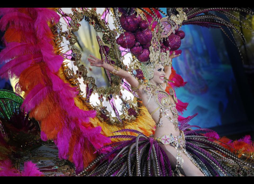 A nomine for Queen of the Santa Cruz carnival shows off her outfit under the watchful eyes of the jury at Santa Cruz de Tenerife on the Spanish Canary island of Tenerife, February 15, 2012. (DESIREE MARTIN/AFP/Getty Images)