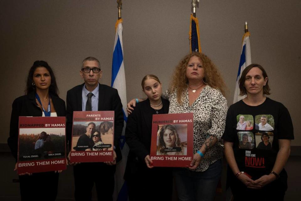 Family members of hostages and victims of Hamas violence pose with posters of their missing or killed family members during the North American Mayors Summit Against Antisemitism on Wednesday, Nov. 15, 2023, at the W Hotel in Fort Lauderdale. From left to right: Natalie Sanandaj, survivor of a music festival where many Jewish people were killed, Diego Engelbert, whose family members are hostages of Hamas, Shemesh Casarotti Kalfa, 17, whose brother was killed by Hamas, Natalia Casarotti, her mother, and Maayan Sigil-Koren pose with posters of their missing or killed family members.