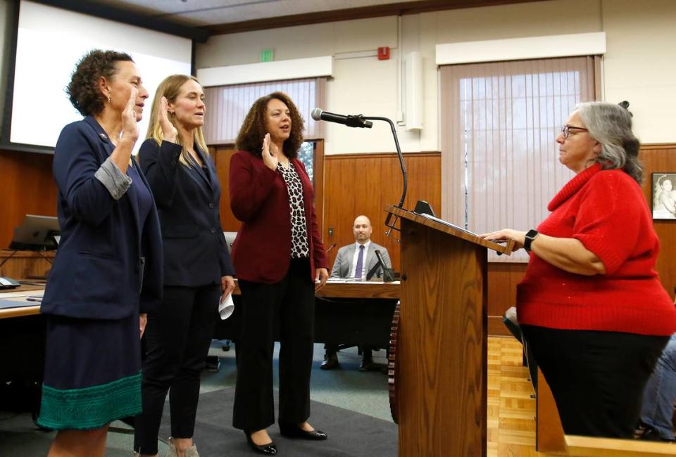 From left, Michelle Shoresman, Emily Francis and Erica Stewart take the oath of office on Friday, Dec. 9, 2022, administered by San Luis Obispo City Clerk Teresa Purrington.