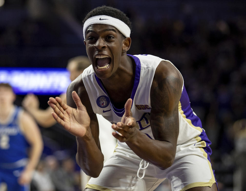 James Madison guard Xavier Brown (0) reacts after a basket during the first half of an NCAA college basketball game against Buffalo in Harrisonburg, Va., Wednesday, Nov. 29, 2023. (Daniel Lin/Daily News-Record Via AP)