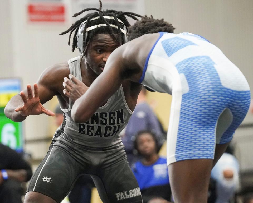 Jensen Beach's Mikel Pierce-Walker (left) wrestles Apopka's Tamarion Kendrick in the 138 pound match during the Cradle Cancer Invitational wrestling tournament on Saturday, Jan. 7, 2023, at Jensen Beach High School. 