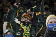 A spectator celebrates in the stands during the second half of an NFL divisional playoff football game between the Green Bay Packers and the Los Angeles Rams Saturday, Jan. 16, 2021, in Green Bay, Wis. (AP Photo/Morry Gash)