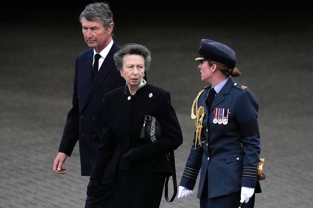 Britain's Princess Anne, Princess Royal, (2nd R) and Vice Admiral Timothy Laurence (L) are greeted by Station Commander Group Captain McPhaden (R) having disembarked from the C-17 carrying the coffin of Queen Elizabeth II at the Royal Air Force Northolt airbase on September 13, 2022, before it is taken to Buckingham Palace, to rest in the Bow Room.