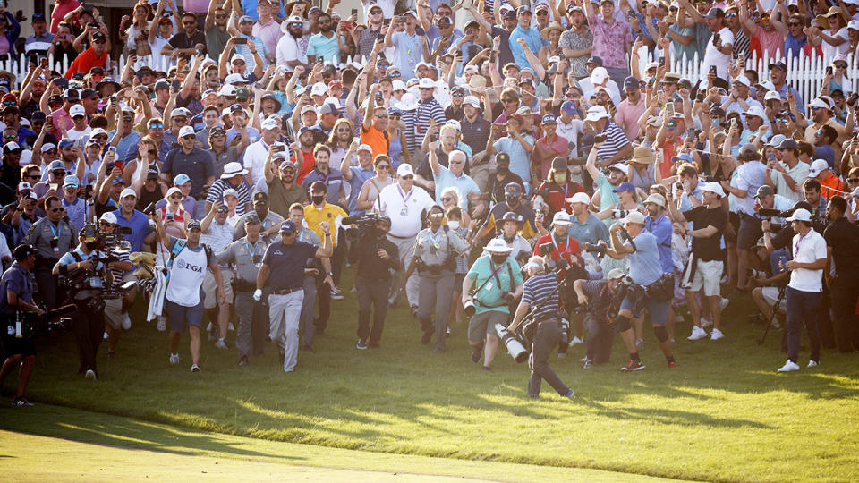 Thousands of fans, pictured here flooding the course as Phil Mickelson made his way to the 18th green.