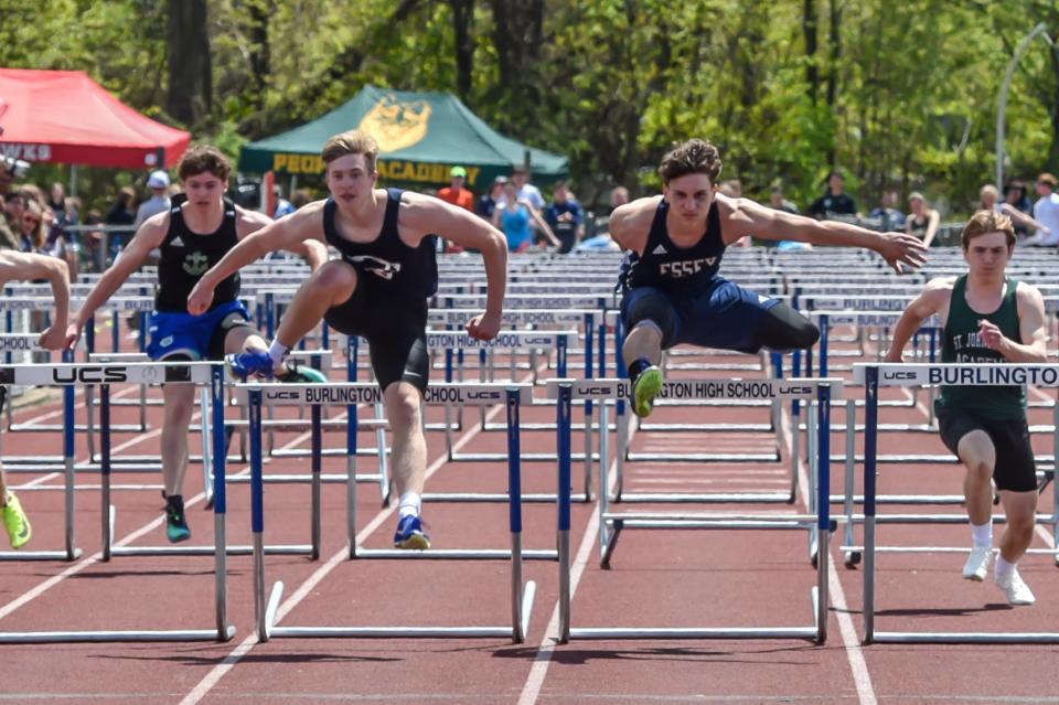 Mount Mansfield's Avery Gilbert just gets by Essex's Sanjin Hadzic to win the 110 meter hurdles at the 51st annual Burlington High School Track and Field Invitational on Saturday.