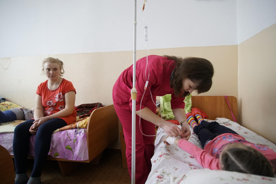 Nurse attends the child in Rivne Regional Children's Hospital, Ukraine on March 14, 2019. As Ukrainians prepare to go the polls in a presidential election March 31, millions of Ukrainians, an estimated one in 10, have left their country to seek the opportunity of working abroad, as many see no hope if they remain at home.(AP Photo/Mstyslav Chernov)