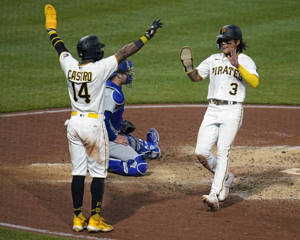 Pittsburgh Pirates' Ji Hwan Bae (3) is greeted by Rodolfo Castro (14) after both scored on a double by Jason Delay during the seventh inning of a baseball game against the Los Angeles Dodgers in Pittsburgh, Wednesday, April 26, 2023. (AP Photo/Gene J. Puskar)