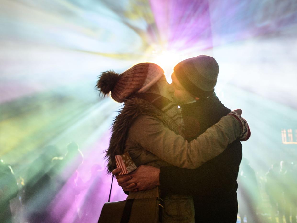 couple kissing at a festival