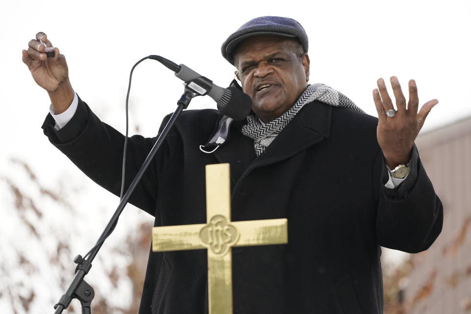 Anderson United Methodist Church senior pastor Rev. Joe May, holds part of the communion packet in his hand as he presides over an outdoor First Sunday service that is broadcast via a live digital feed to the church's website and its Facebook page in addition to being broadcast on a local FM station, Dec. 6, 2020, in Jackson, Miss. Because of covid, the church has embraced the digital means by which to air the worship services to its members. However, for First Sunday services, the members gather in the church's parking lot to celebrate the receiving of communion in their personal vehicles. (AP Photo/Rogelio V. Solis)