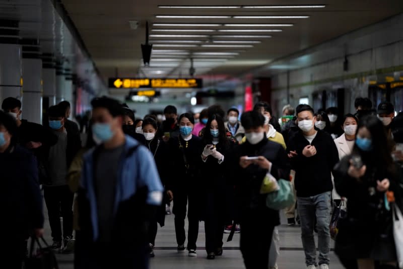 Passengers wearing face masks are seen at a subway station after the city's emergency alert level for coronavirus disease (COVID-19) was downgraded, in Shangha