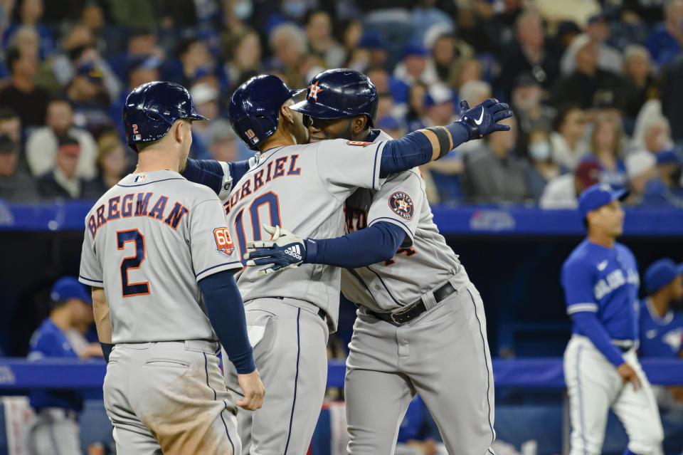 Houston Astros' Yordan Alvarez, right, celebrates with teammates after hitting a home run during the sixth inning of a baseball game against the Toronto Blue Jays on Friday, April 29, 2022, in Toronto. (Christopher Katsarov/The Canadian Press via AP)