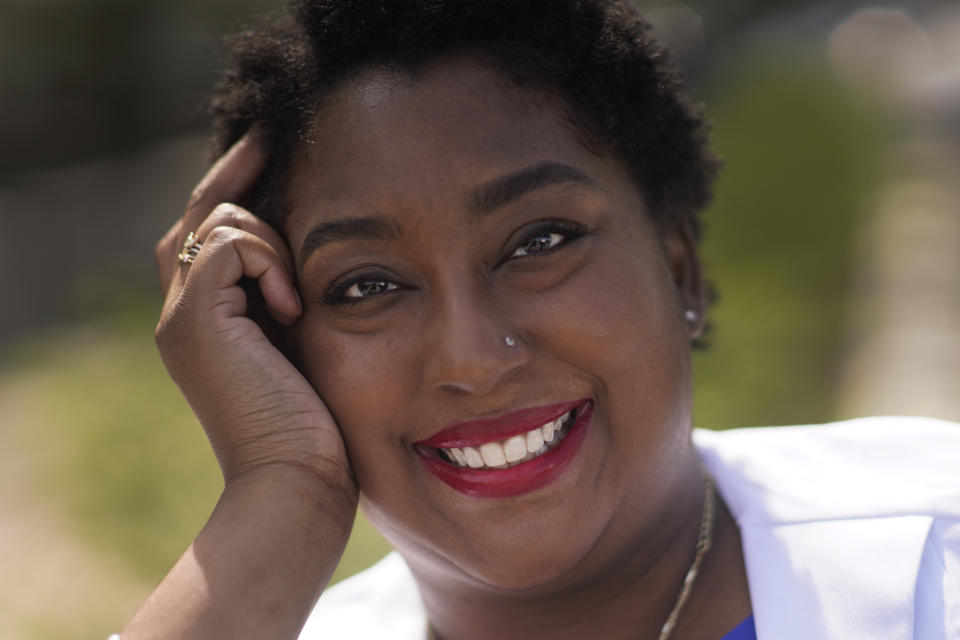 Dr. Brandi Jackson poses for a portrait in the Bronzeville neighborhood of Chicago, Sunday, May 2, 2021. ‘’I remember being young and being told in school that I can’t be smart, because of where I’m from, being told your hair is ugly,’’ she says. ‘’You learn to live with the kind of pain that comes just for being. Just for walking down the street. You can’t name it when you’re that young. It does something to your psyche.’’ (AP Photo/Charles Rex Arbogast)