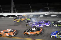 Ryan Blaney (12), Ty Gibbs (54) and Christopher Bell (20) collide at the start of a wreck in Turn 4 during the NASCAR Cup Series auto race at Daytona International Speedway, Saturday, Aug. 26, 2023, in Daytona Beach, Fla. (AP Photo/Rob Sweeten)