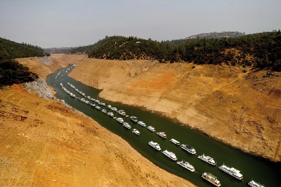 FILE - Houseboats rest in a channel at Lake Oroville State Recreation Area in Butte County, Calif., on Aug. 14, 2021. Months of winter storms have replenished California's key reservoirs after three years of punishing drought. (AP Photo/Noah Berger, File)