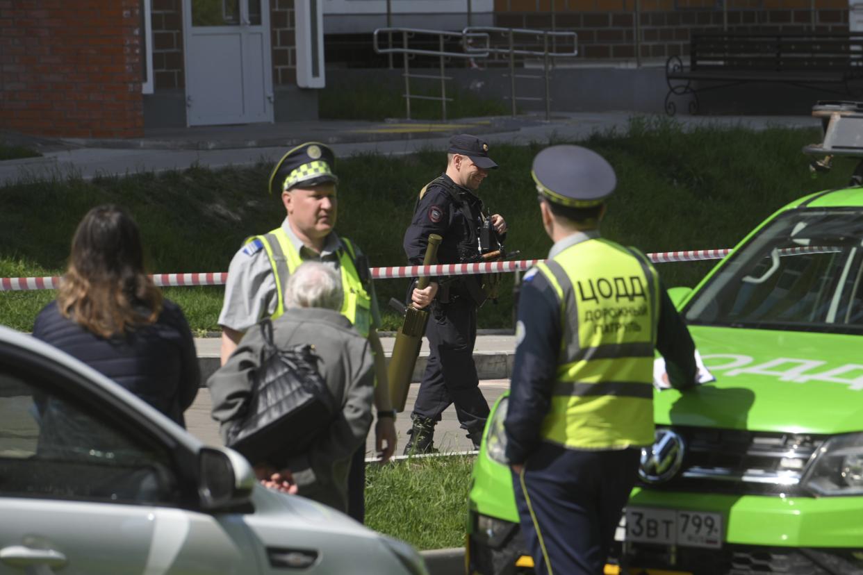 Police officers guard an area where a Ukrainian drone damaged an apartment building in Moscow, Russia, Tuesday, May 30, 2023. (AP Photo)