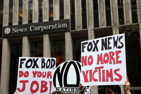 Protestors from the National Organization for Women of New York (NOW-NYC) hold a protest in front of Fox News Channel and the News Corporation Headquarters, following the firing of Bill O'Reilly, in New York City, U.S., April 20, 2017. REUTERS/Shannon Stapleton