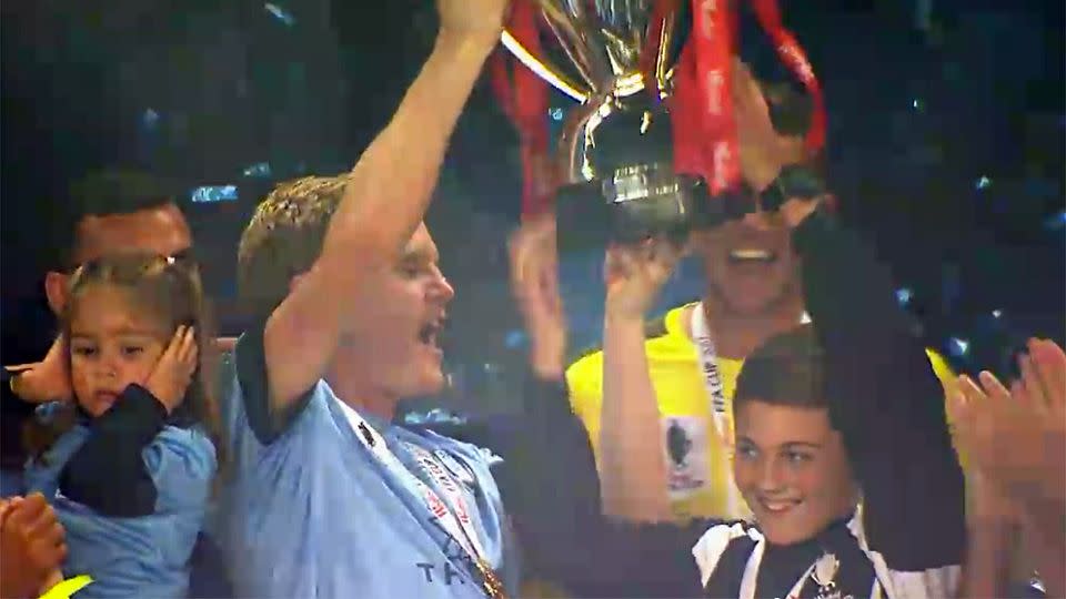 The ball boy lifting the FFA Cup with Sydney FC. Pic: Fox Sports