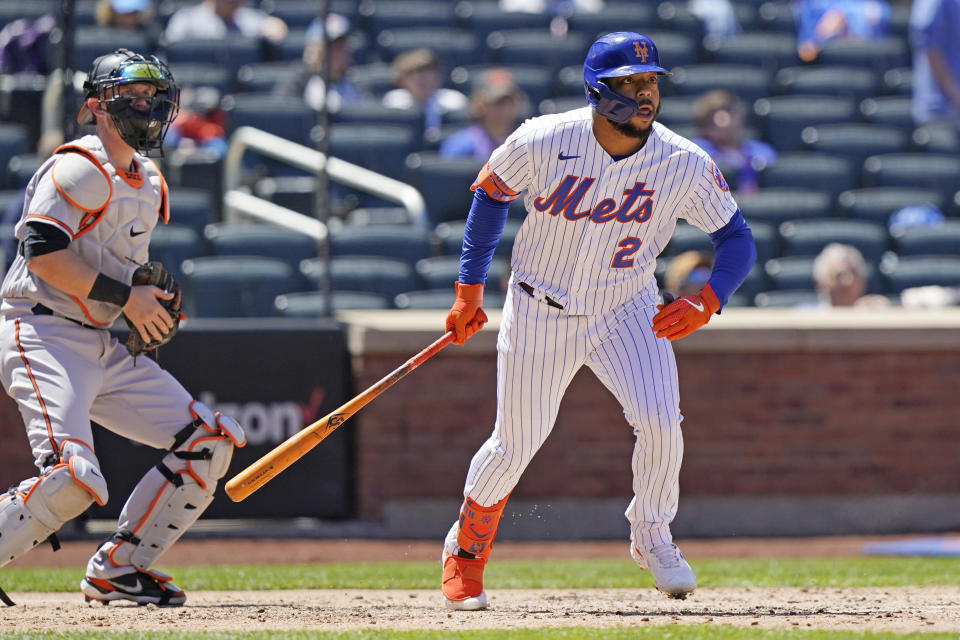New York Mets' Dominic Smith (2) and Baltimore Orioles catcher Chance Sisco watch Smith's fifth-inning RBI double in a baseball game, Wednesday, May 12, 2021, in New York. (AP Photo/Kathy Willens)