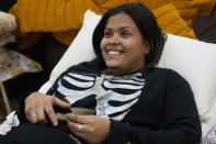 Carolina Gonzalez of Venezuela lays on a cot in the Chicago City Life Center Wednesday, Nov. 29, 2023, in Chicago. The community center and church welcomed about 40 migrants who were previously living at police stations and airports. (AP Photo/Erin Hooley)