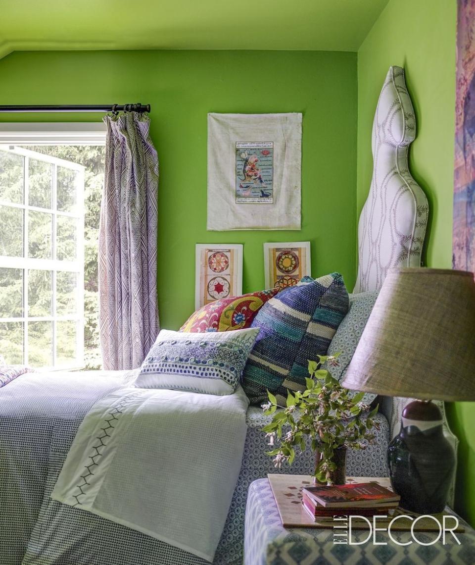 connecticut country house bedroom with chartreuse walls and vivid textiles as well as wall prints