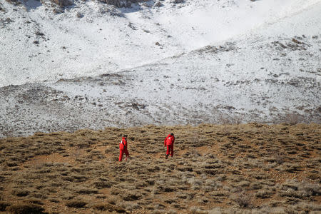 Members of emergency and rescue team search for the plane that crashed in a mountainous area of central Iran, February 19, 2018. REUTERS/Tasnim News Agency