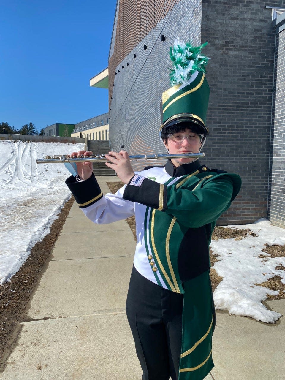 Student Lucas Cabral showcasing a sample Dover Marching Band uniform